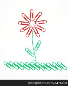 Beautiful flower on a grass from office paper clips for a paper