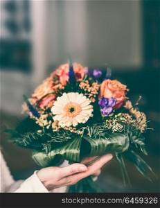 Beautiful flowers bunch with Gerbera and roses in female hand