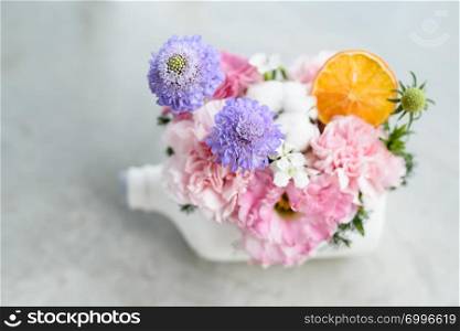 beautiful flowers in white bottle pot