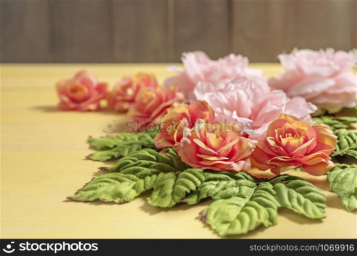 beautiful flowers with leaves on wooden background. top view beautiful flowers with leaves