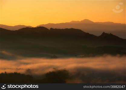 Beautiful fog and golden light in the morning forest with green mountains. Baan Jabo, Mae Hong Son, Thailand.. Fog in forest.