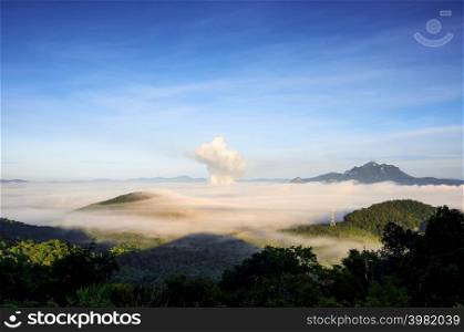 Beautiful fog in the morning forest with green mountains and high voltage pole. Pang Puay, Mae Moh, Lampang, Thailand.. Fog in forest.