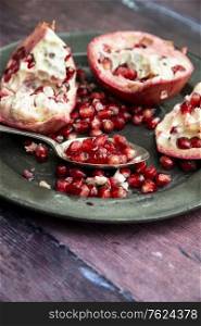 Beautiful food portrait of pulled Pomegranate and seeds with vintage texture background