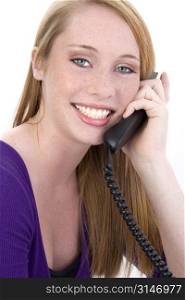 Beautiful fourteen year old girl laughing on telephone. Shot in studio over white.