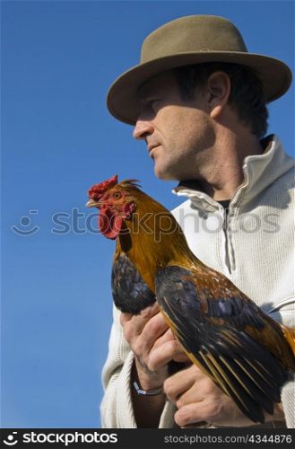 beautiful french man with hat and his rooster