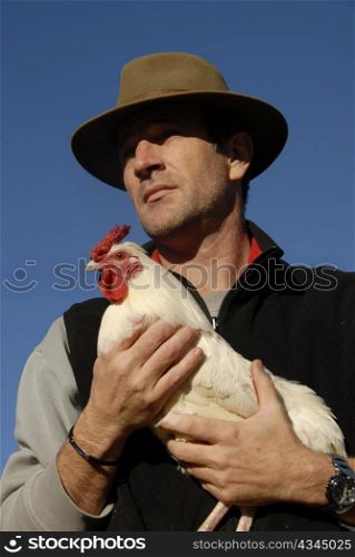 beautiful french man with hat and his white chicken