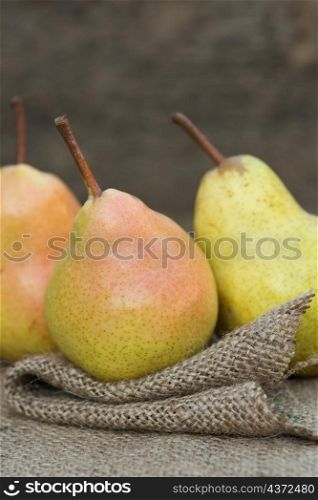 Beautiful fresh pears in rustic wooden setting