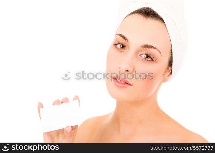 Beautiful fresh woman taking white card - blank. Dressing in pure white towel on the white background