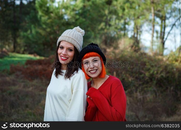 Beautiful friends in the forest in a winter day