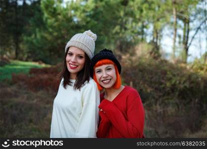 Beautiful friends in the forest in a winter day