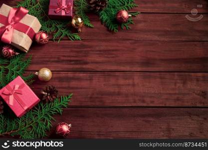 Beautiful gift boxes, fir branches and Christmas balls on wooden background. Place for text.. Beautiful gift boxes, fir branches and Christmas balls on wooden background.
