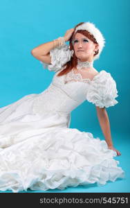 Beautiful ginger in white dress of Snow Queen blue background