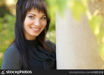 Beautiful girl&acute;s portrait near the column with soft background