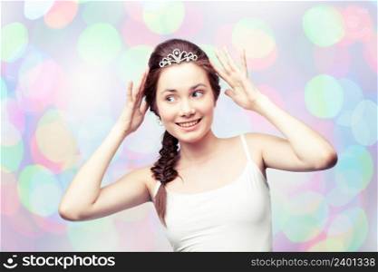 Beautiful girl admiring her diamond tiara