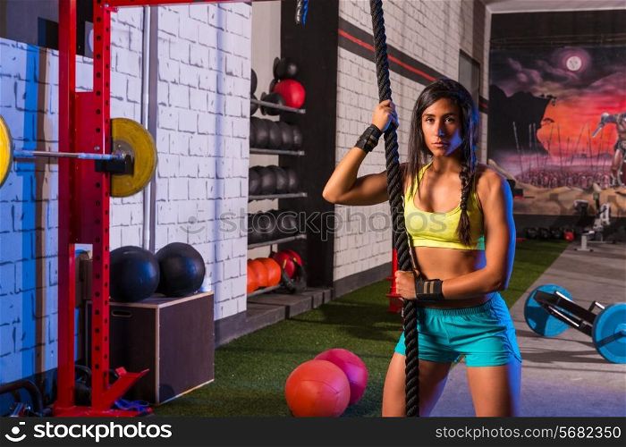 beautiful girl at gym with black rope and fit muscles