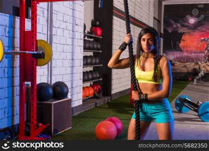 beautiful girl at gym with black rope and fit muscles