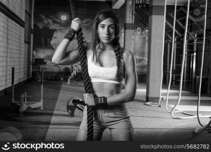 beautiful girl at gym with black rope and fit muscles