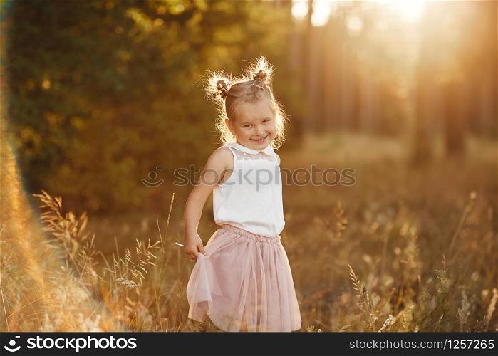 beautiful girl at sunset. children&rsquo;s portrait of a girl.. children&rsquo;s portrait of a girl. beautiful girl at sunset