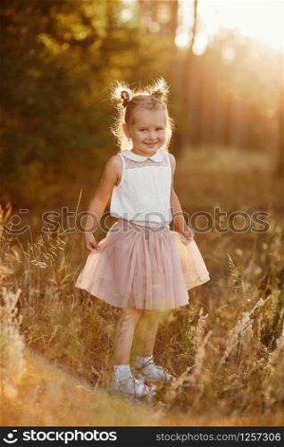 beautiful girl at sunset. children&rsquo;s portrait of a girl.. children&rsquo;s portrait of a girl. beautiful girl at sunset