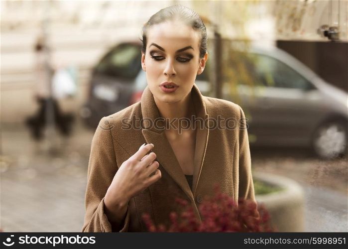 beautiful girl , at the shop-window , she is outside of the shop and looking inside with desire