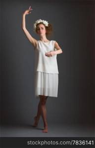 Beautiful girl, ballet dancer wearing white dress, gray background