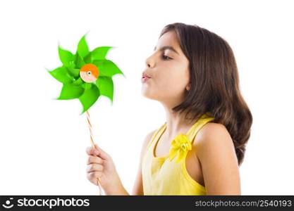 Beautiful girl blowing a plastic windmill