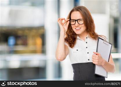 beautiful girl corrects by hand glasses portrait in the office