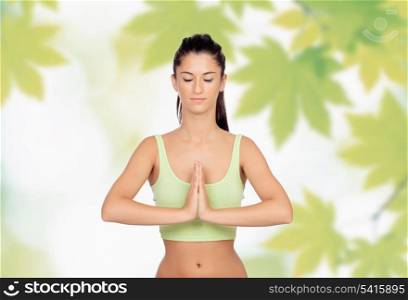 Beautiful girl doing Yoga with big leaves of background