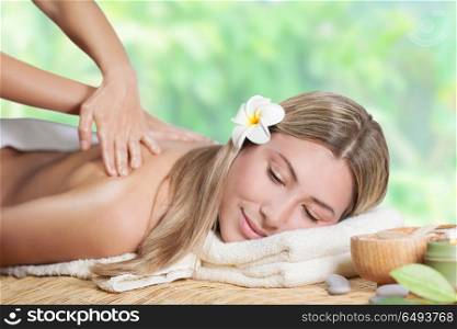 Beautiful girl enjoying day spa on the beach resort, lying down on the massage table and enjoying treatment procedure, health and beauty care concept . Beautiful girl enjoying day spa