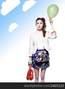 Beautiful girl holding a balloon in one hand and red shoes in another, blue gradient background with clouds