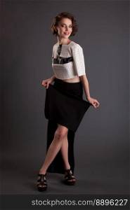 beautiful girl in a black skirt and a white jacket model posing on a black background vintage