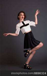 beautiful girl in a black skirt and a white jacket model posing on a black background Pin-up