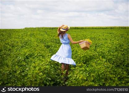 beautiful girl in a blue board is standing on a green field.. beautiful girl in a blue board is standing on a green field