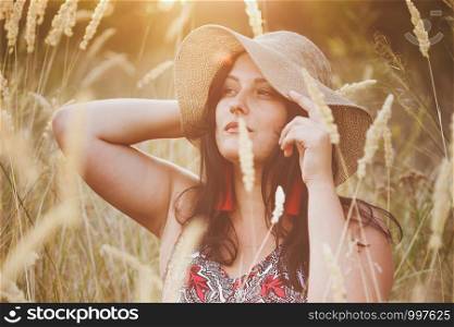 beautiful girl in a meadow at sunset. Mood