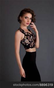 beautiful girl in black skirt model posing on a black background