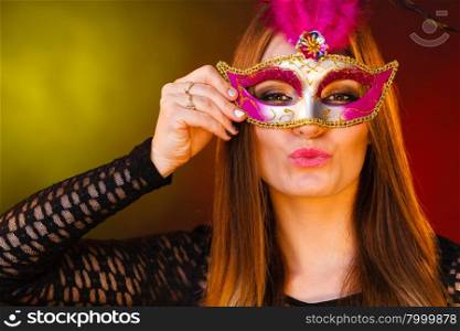 Beautiful girl in carnival mysterious mask. . People celebration concept. Masquerade. Beautiful girl in carnival mysterious mask. Colorful festive background