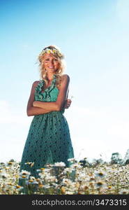 beautiful girl in dress on the daisy flowers field