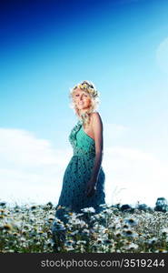 beautiful girl in dress on the daisy flowers field