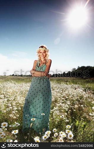 beautiful girl in dress on the sunny daisy flowers field