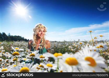 Beautiful girl in dress on the sunny daisy flowers field. Girl in dress on the daisy flowers field