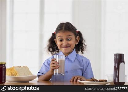 Beautiful Girl in school uniform drinking fresh delicious chocolate milkshake