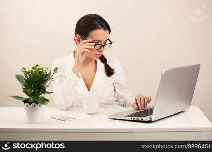 beautiful girl in the office working on the computer