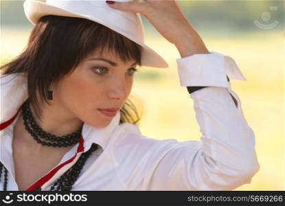 Beautiful girl in the white hat- soft background portrait