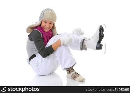 Beautiful girl in winter clothes puts on skates. Isolated on white background