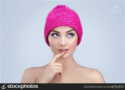 Beautiful girl in winter hat. Perfect makeup. Beauty fashion. Eyelashes. Lips. Cosmetic Eyeshadow. Perfect skin
