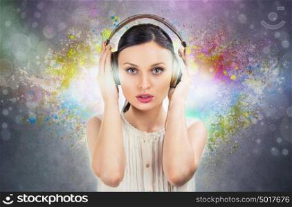Beautiful girl listening to the music with a pair of headphones