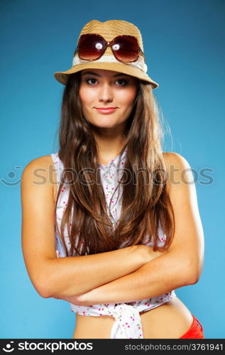 beautiful girl long hair in summer clothes and hat. Studio shot on blue background