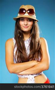 beautiful girl long hair in summer clothes and hat. Studio shot on blue background