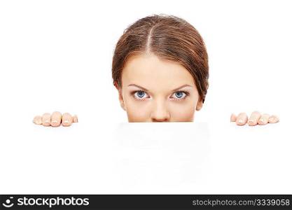 Beautiful girl looks out from under something, isolated
