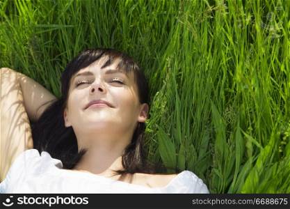 beautiful girl lying down of grass. Copy space